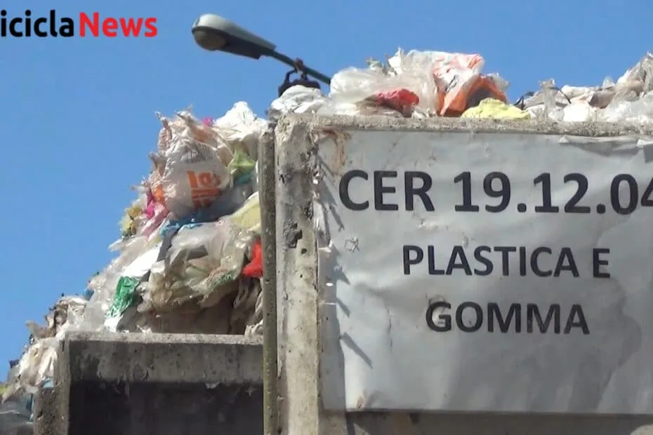 Cassone colmo di sacchi di plastica con il cartello CER 19.12.04 plastica e gomma